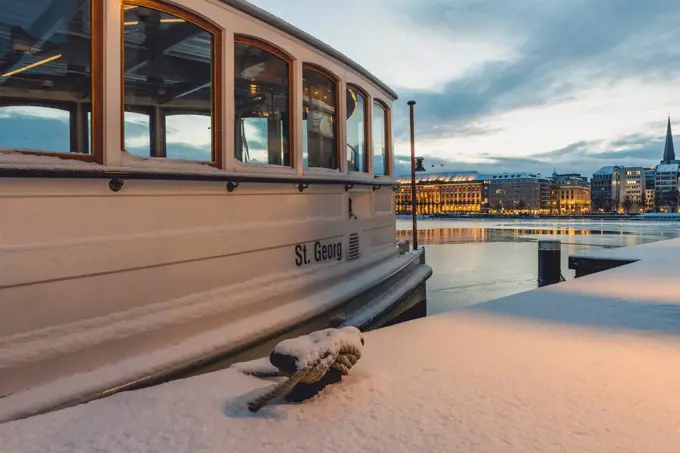 Germany, Hamburg, Inner Alster Lake and tourboat in winter