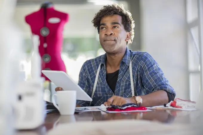 Fashion designer working with tablet on table