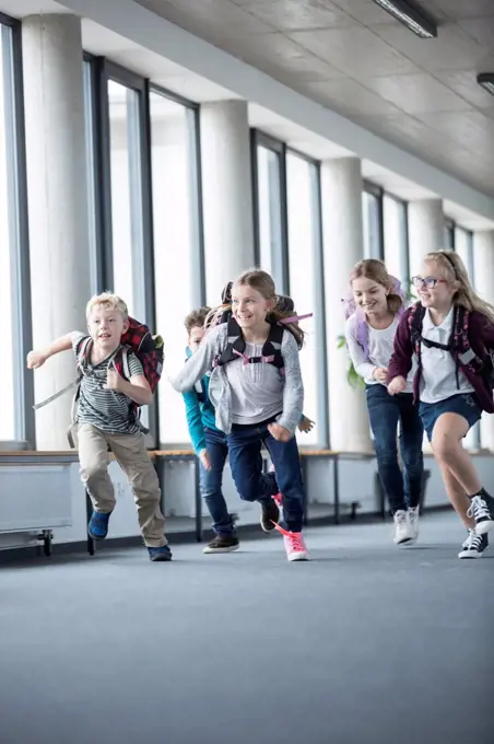 Excited pupils rushing down school corridor