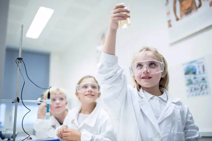 Pupils in science class experimenting with liquid