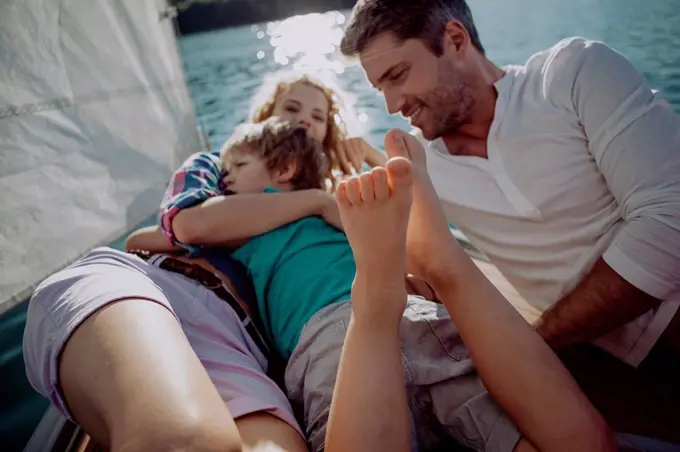 Happy family relaxing on a sailing boat