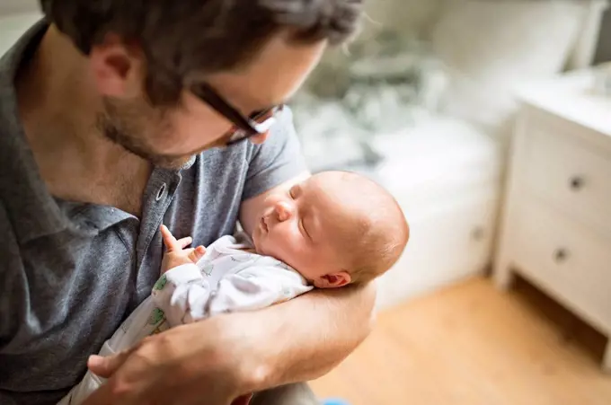 Father at home with his baby daughter