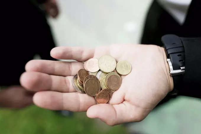 Euro coins in the hand of a businessman