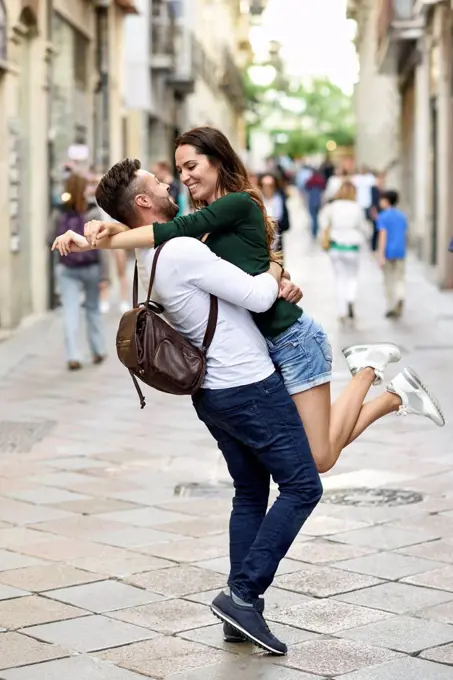 Affectionate happy tourist couple having fun in the city