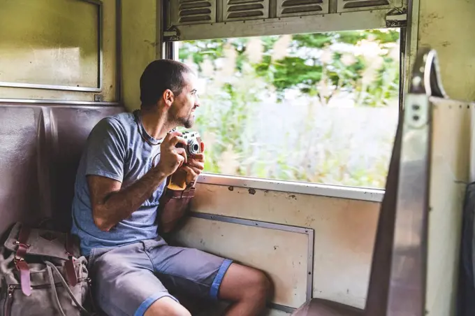 Thailand, Bangkok, tourist travelling by local train