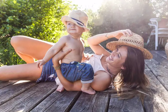 Mother and baby boy having fun on terrace