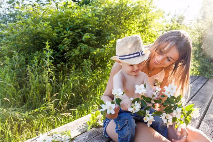 Mother and baby boy having fun together on terrace