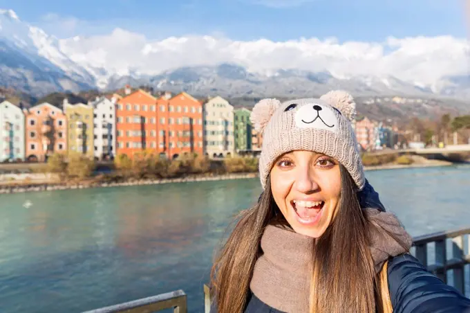 Austria, Innsbruck, portrait of excited woman taking selfie