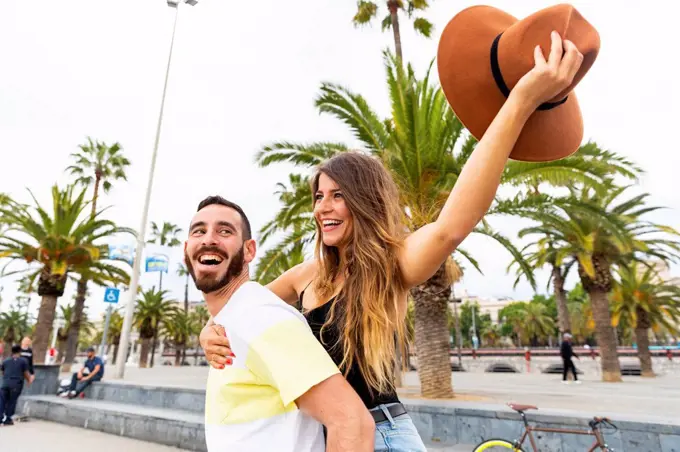 Spain, Barcelona, couple having fun on seaside promenade