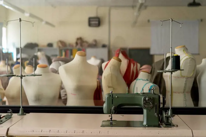 Dressmaker's models and sewing machine in fashion designer's studio