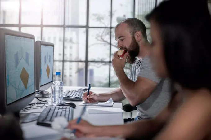 Adult Education, student eating an apple at computer training centre