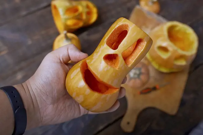 Man holding carved Halloween pumpkin