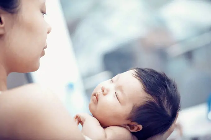 Portrait of baby girl hold by her mother