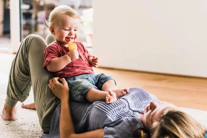 Mother and son at home eating ice lolly