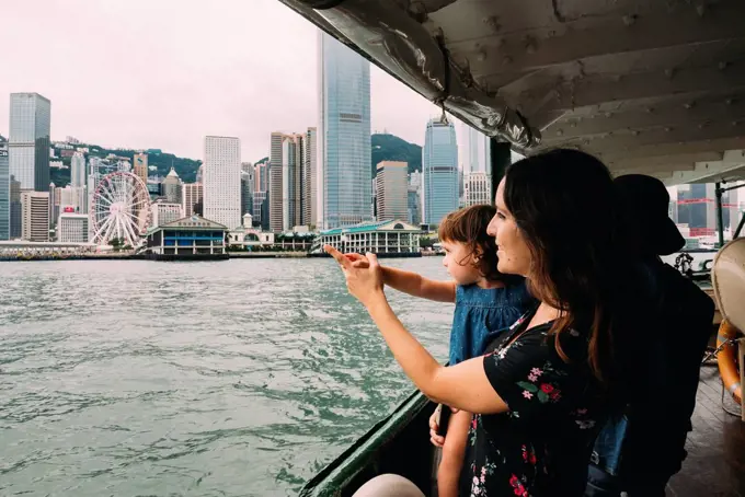 China, Hong Kong, mother and little daughter crossing the river by ferry from Kowloon to Hong Kong Island