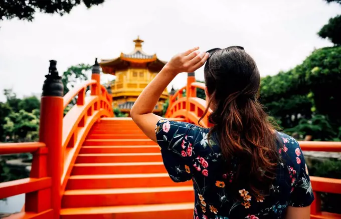 China, Hong Kong, Diamond Hill, Nan Lian Garden, Female tourist lookint at Golden Pavilion of Absolute Perfection