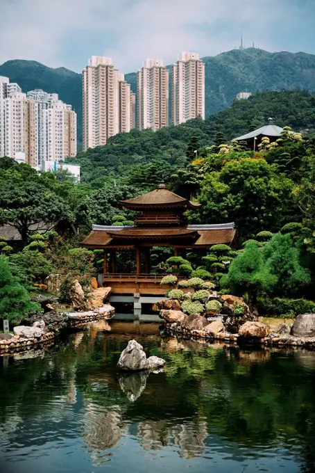 China, Hong Kong, Diamond Hill, Pond in Nan Lian Garden surrounded by skyscrapers