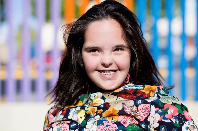 Teenager girl with down syndrome smiling, braces