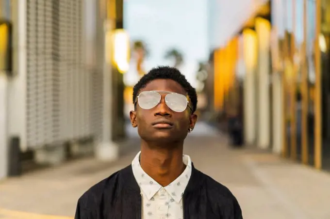 Portrait of a young black man, wearing a glasses