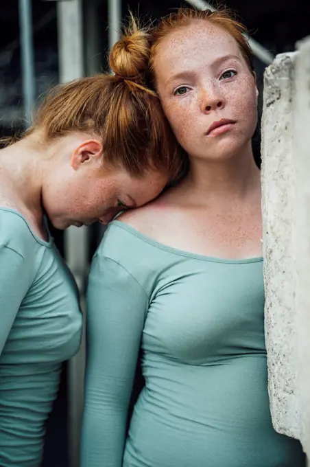 Redheaded twins, head supported