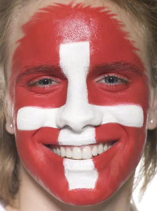 Man with Swiss flag painted on face, close-up, portrait