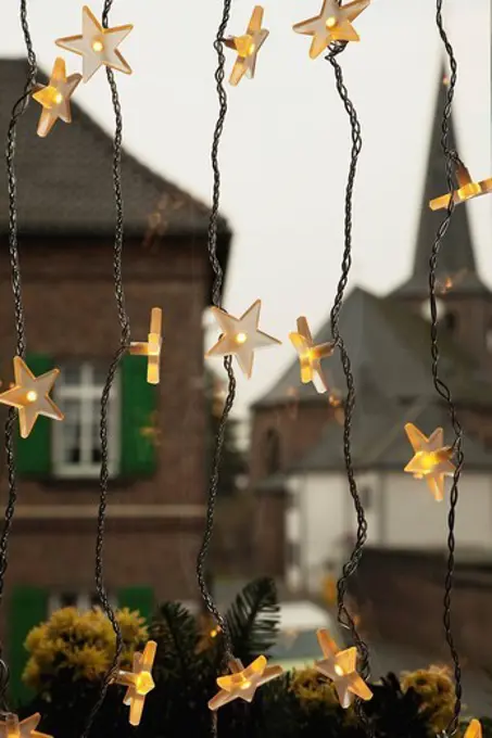 Germany, Cologne, Close up of illuminated stars as christmas window decoration