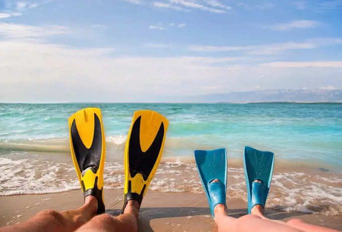 Croatia, Zadar, Couple with flippers relaxing on beach