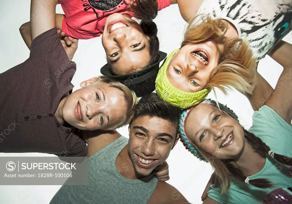 Group of children in circle, smiling and looking down at camera, Germany. 08/31/2013