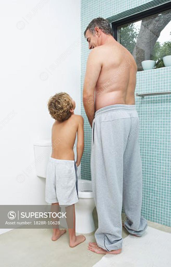 Father and Son Urinating SuperStock