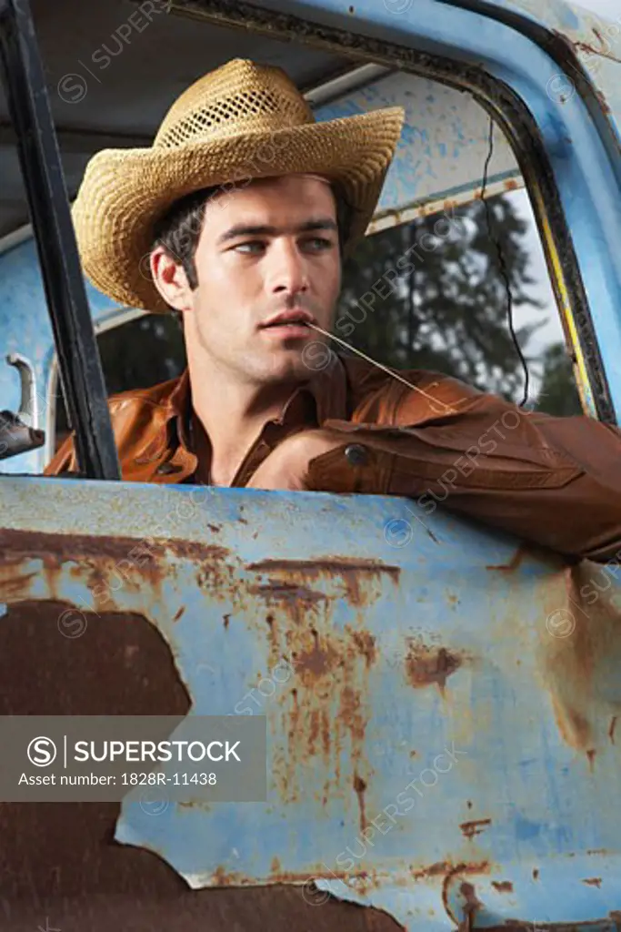 Man In Cowboy Hat and Rusty Truck   
