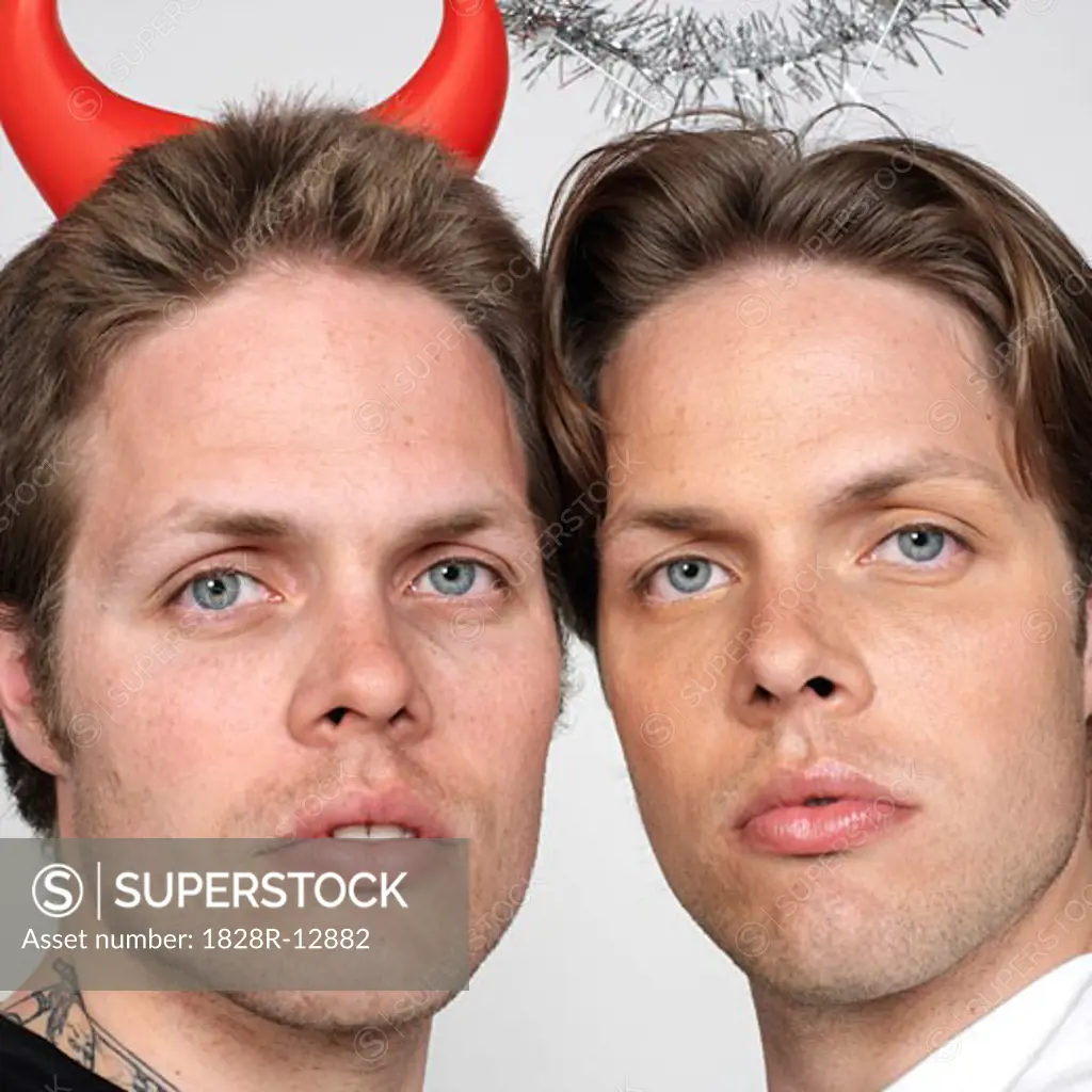 Portrait of Twin Brothers Dressed Like Devil and Angel   