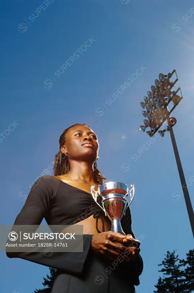 Champion Athlete Holding Trophy   