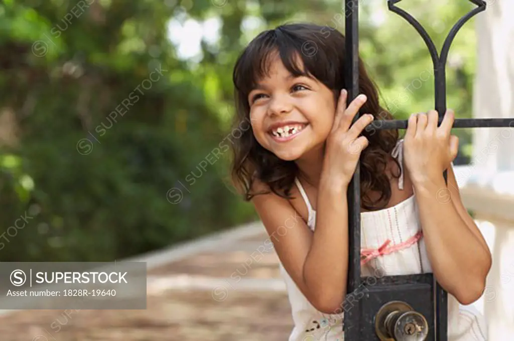 Portrait of Girl Standing by Gate   