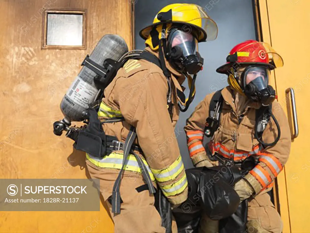 Firefighters Carrying Dummy out of Smoky Building   