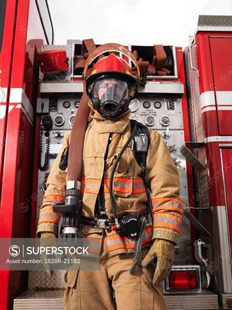 Fireman Pulling Fire Hose from Fire Truck   