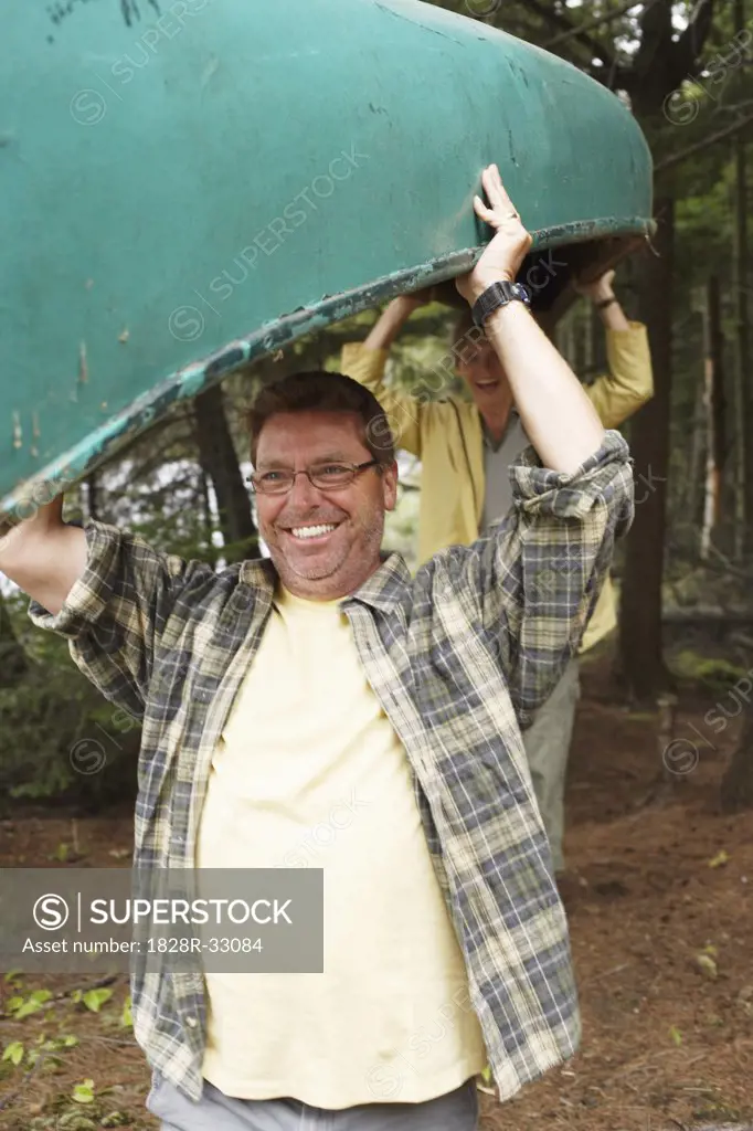 Couple Carrying Canoe   