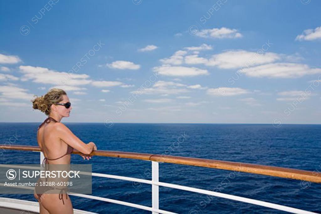 Woman in Bikini Looking at Ocean from Cruise Ship SuperStock