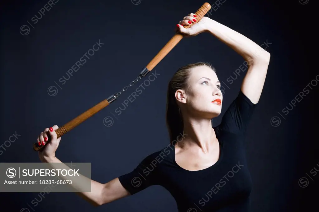 Woman Holding Nunchucks