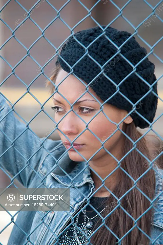 Portrait of Woman behind Fence