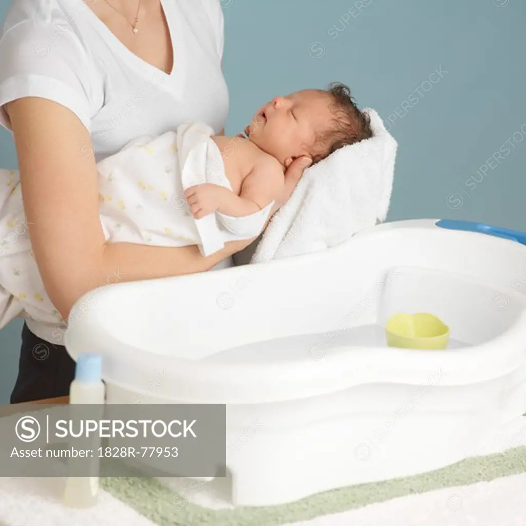 Mother Washing Newborn Baby