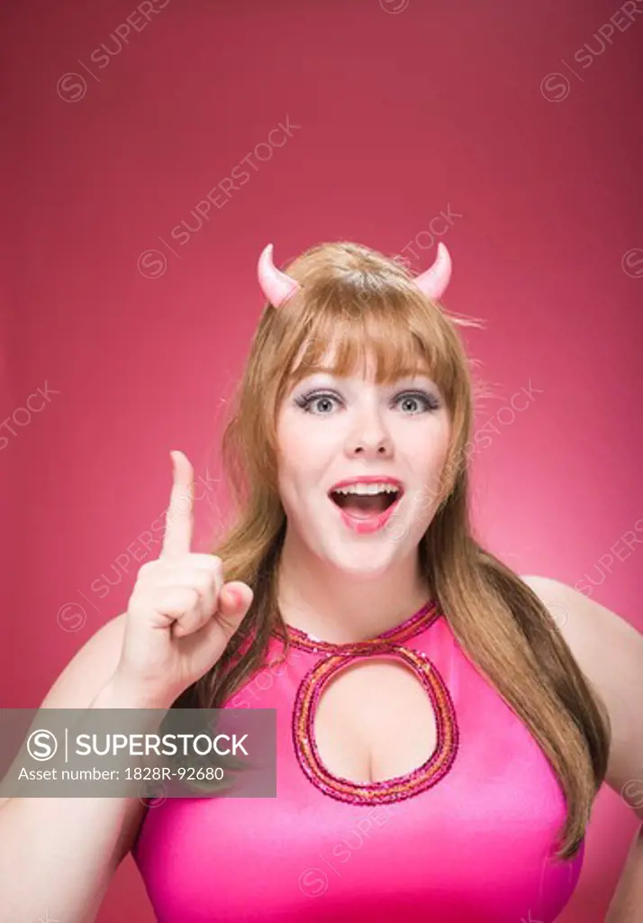 Portrait of Woman Wearing Devil Horns Making Hand Gesture