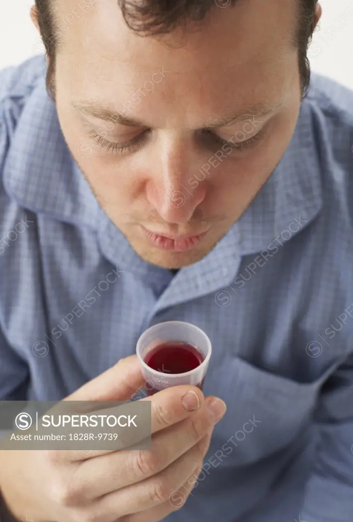 Man Drinking Cough Syrup   