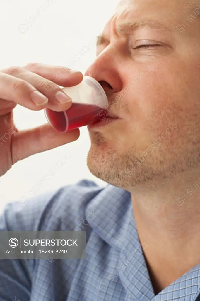 Man Drinking Cough Syrup   