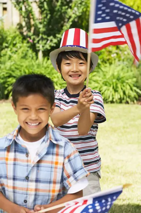 Portrait of Boys Holding American Flags   