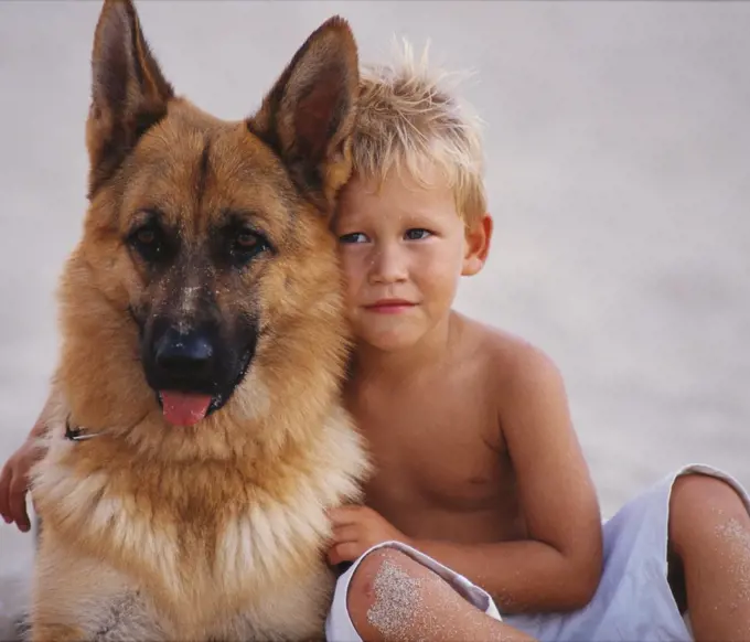 Portrait of Boy Hugging Dog   