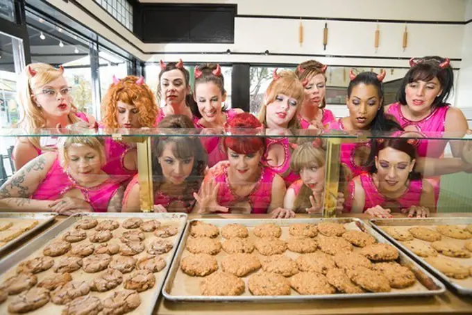 Women Wearing Devil Horns at a Bakery, Oakland, Alameda County, California, USA