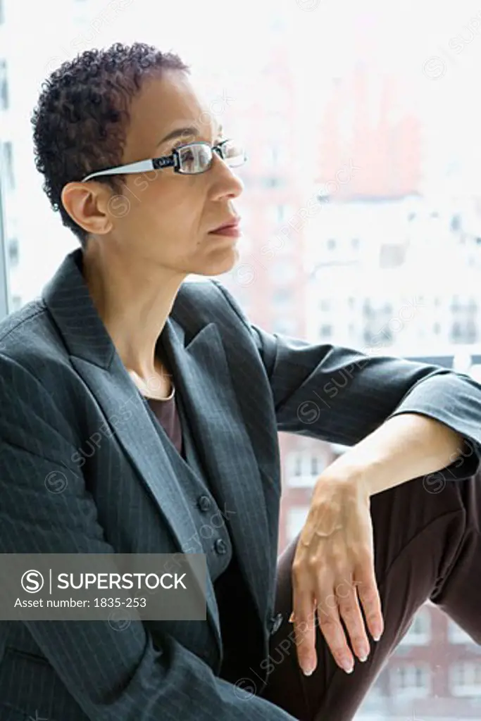 Businesswoman sitting with her hand on her knee