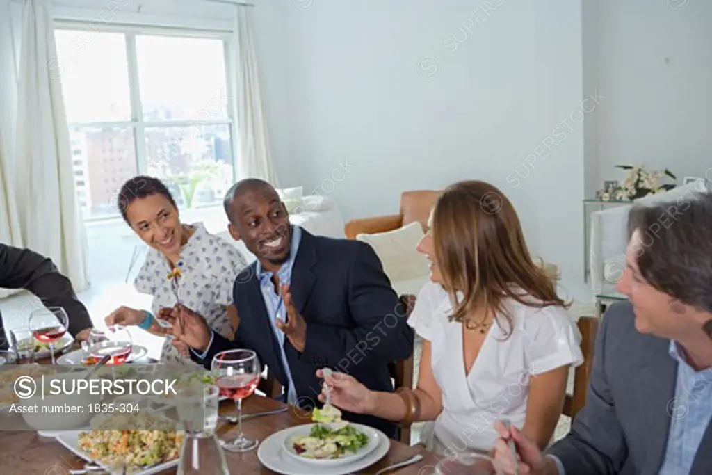 Two men and two women sitting at a dining table