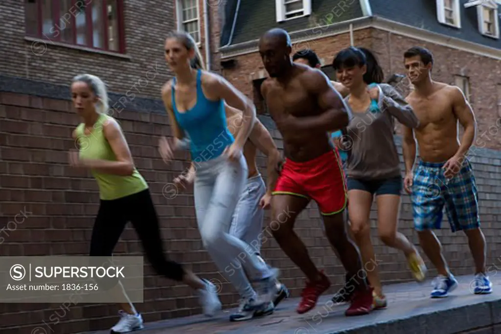 Group of people jogging on the sidewalk