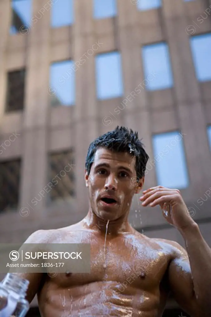 Portrait of a young man with water dripping from his face